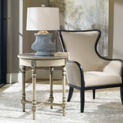Uttermost Sandy wing back armchair in beige and dark brown fabric with plush cushioning and elegant design.