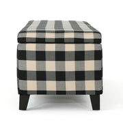 Black Noble House storage ottoman with cushioned seating and hidden storage compartment, modern design for living room use.