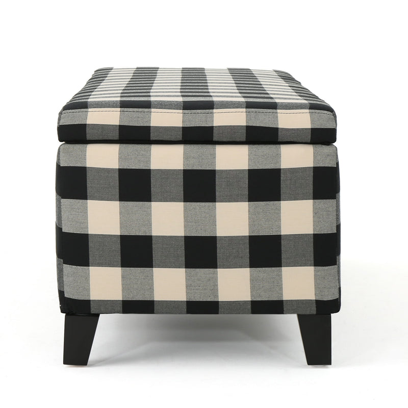 Black Noble House storage ottoman with cushioned seating and hidden storage compartment, modern design for living room use.