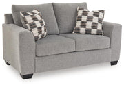 Loreo stationary loveseat by Benchcraft® featuring plush cushions, cozy armrests, and stylish fabric upholstery.