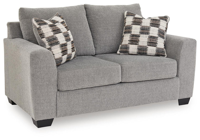 Loreo stationary loveseat by Benchcraft® featuring plush cushions, cozy armrests, and stylish fabric upholstery.