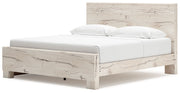 Signature Design by Ashley Lawroy panel bed with built-in storage drawers, showcasing a modern wooden bed frame with ample storage space.