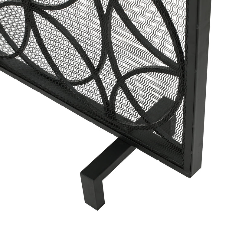 Noble House Thayer single panel iron fireplace screen with geometric design, black metal with intricate cutout pattern.