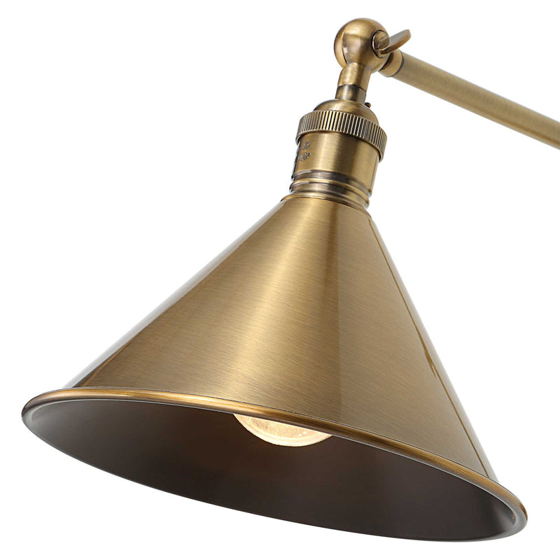 Uttermost Exeter gold 1-light adjustable sconce with sleek design and modern finish, mounted on a wall with visible arm and shade.