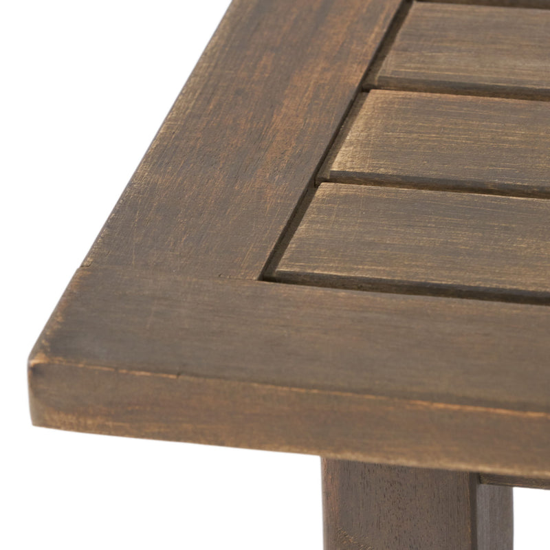 Noble House Kinesis outdoor side table with slatted top and wood frame, ideal for patio or garden spaces.