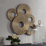 Uttermost Ahmet gold rings wall decor with overlapping circular metal accents for modern interior design.