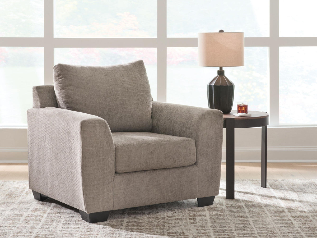 Loreo arm chair by Benchcraft® featuring plush upholstery and modern design, shown from a front angle.