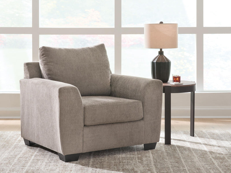 Loreo arm chair by Benchcraft® featuring plush upholstery and modern design, shown from a front angle.