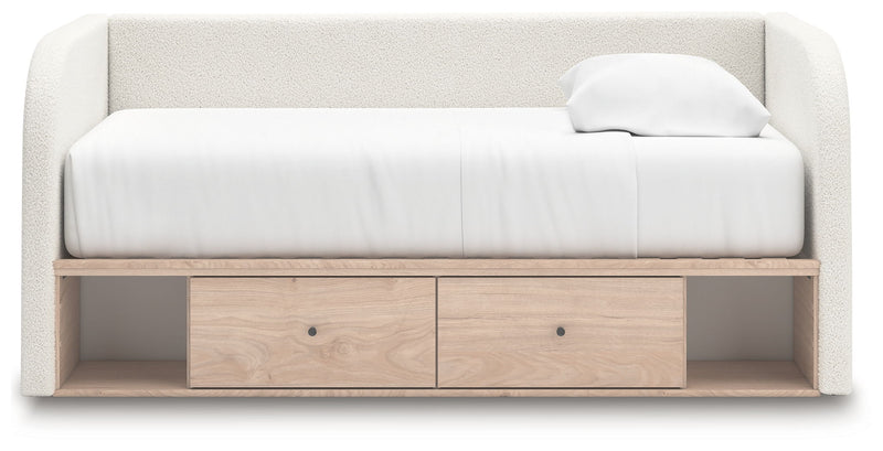 Upholstered Signature Design by Ashley® Arloster day bed with plush fabric and wooden legs, ideal for guest rooms or lounges.