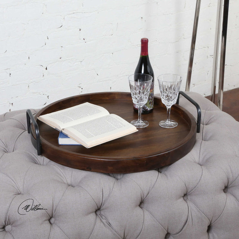 Dark brown round wooden tray by Uttermost featuring a smooth, polished surface and sturdy rim, ideal for serving or decorative use.