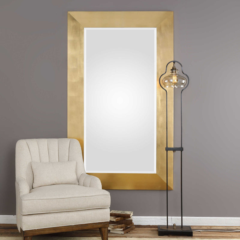 Gold wall mirror by Uttermost, Chaney style with a sleek round frame, hanging on a wall for stylish home decor.