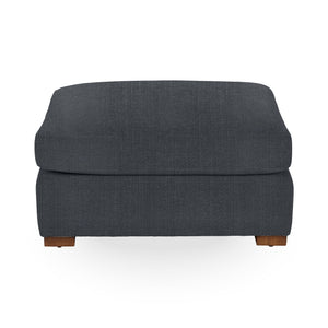 Classic Home Audrey upholstered ottoman with fabric cushioning and wooden legs, ideal as a footrest or extra seating.