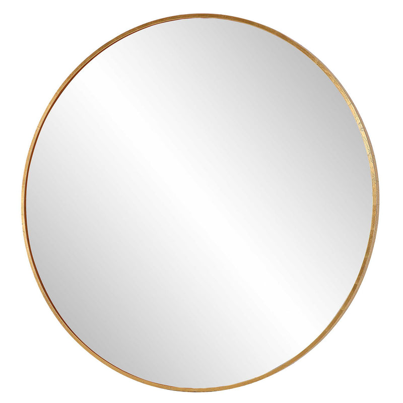 Uttermost Junius round wall mirror with a sleek frame, hanging on a wall, reflecting a modern interior.