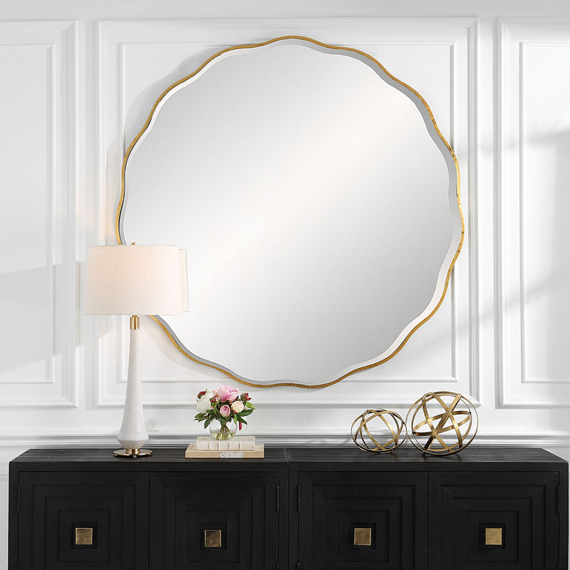 Uttermost Aneta round wall mirror with a sleek metal frame hanging on a modern wall.