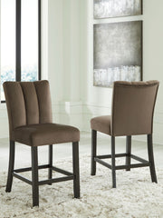 Two Jeshina upholstered barstools in mocha with wooden legs, part of Signature Design by Ashley® stool set, shown from a side view.