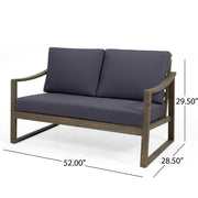 Noble House Samwell outdoor 2-piece coffee table and loveseat set with wicker frames and plush cushions on a patio.