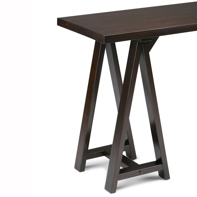 Handcrafted Simpli-Home console sofa table with sawhorse-style legs, featuring a sleek wooden surface for living room decor.