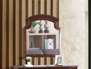 Glory Furniture Summit mirror with a sleek, modern frame hanging on a wall, reflecting a bright interior space.