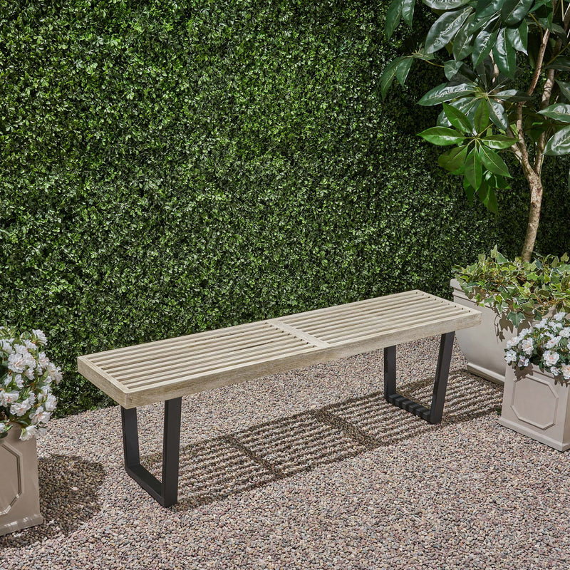 Noble House Intrinsic outdoor dining bench with slat top, sturdy wooden construction, ideal for patio or garden seating.