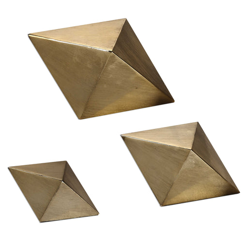 Set of three champagne-colored Rhombus accents sculptures by Uttermost, modern geometric decorative figurines on a neutral background.