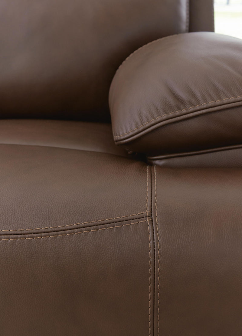 Signature Design by Ashley Vonryan power reclining loveseat in tobacco with adjustable headrests and built-in console, showing plush upholstery.