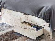 Signature Design by Ashley Lawroy panel storage bed with built-in drawers and modern wood finish in a bedroom scene.
