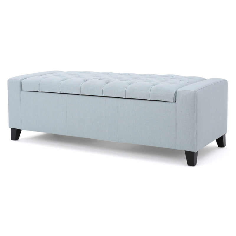 Noble House Guernsey storage ottoman with tufted top, fabric upholstery, and sturdy wooden legs, serving as stylish home storage.