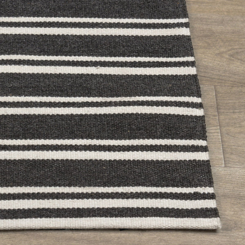 Classic Home Palma stripe area rug with bold black and white pattern, soft textured fabric for modern living spaces.