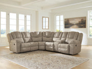 Signature Design by Ashley Pearce-Pike reclining sectional sofa with plush cushions and modern design, shown in a cozy living room setting.