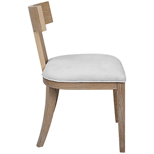 Uttermost Idris armless side chair with upholstered seat and wooden legs, modern design for living or dining areas.