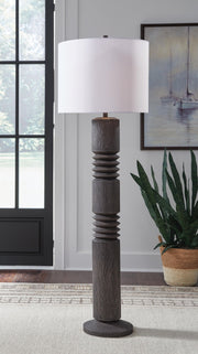 Distressed black Fainwell floor lamp by Signature Design Ashley® with a sleek, modern design and sturdy base for living room lighting.