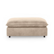 Classic Home Caplan upholstered ottoman with plush fabric and sturdy wooden legs, perfect for living room decor.